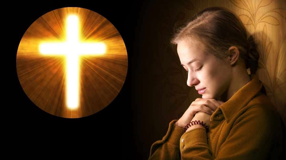 a woman praying with her hands together