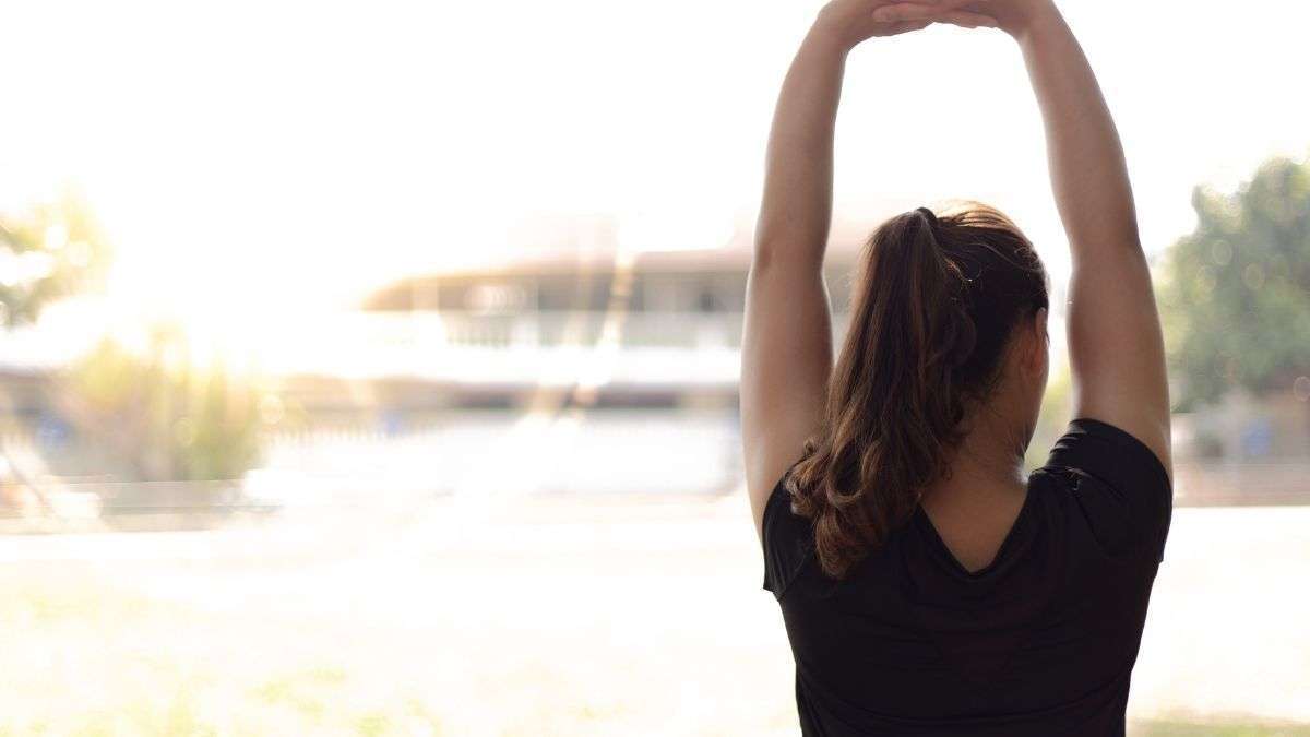 a woman stretching her arms nutruring your soul