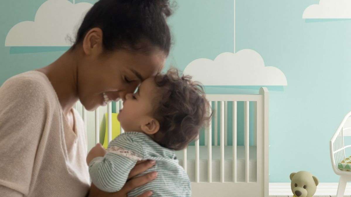 a woman holding a baby Feat 725 -P