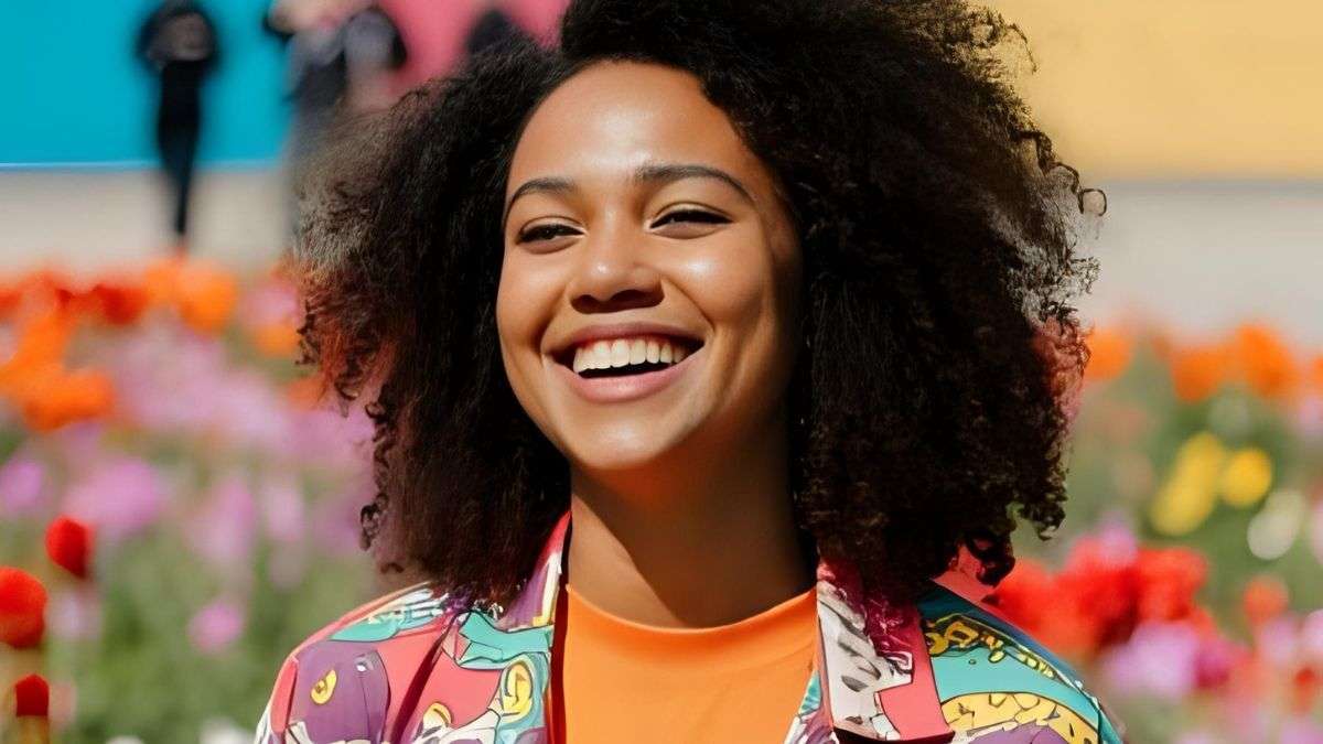 a woman smiling with afro hair