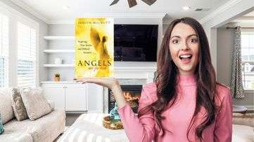 Woman holding book called angels are for real